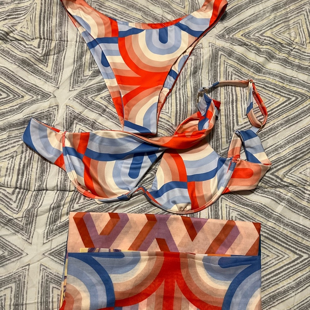 One side shoulder Orange, Blue and Tan three piece bikini.